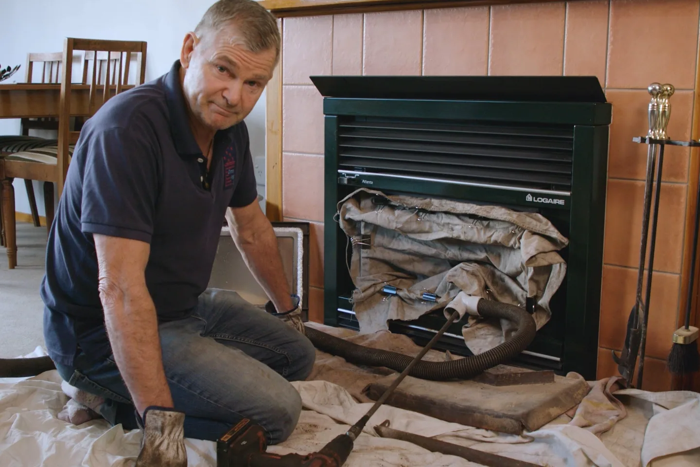Alan from Chimney Magic has covered the floor with drop sheets and sealed the wood burner for a no mess chimney sweep